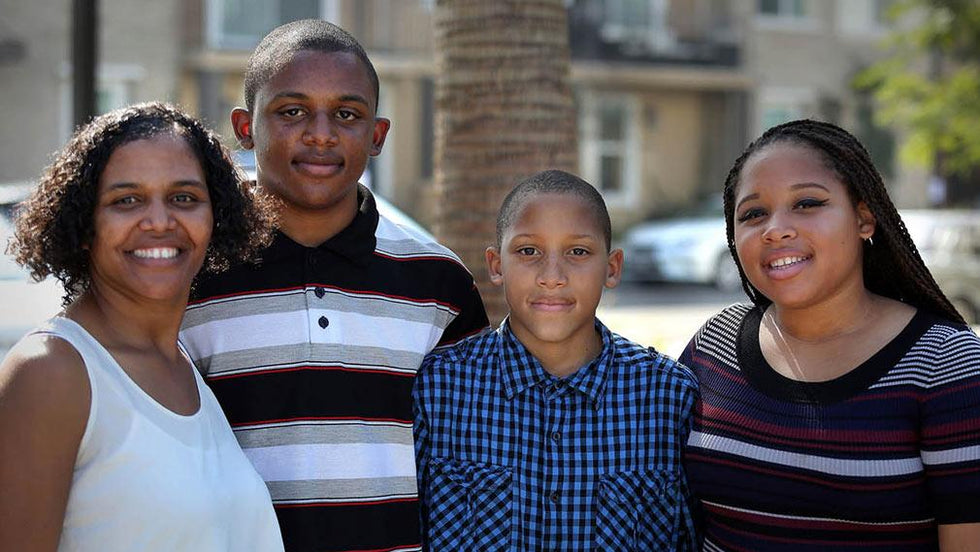 A family that is excited to have moved in to their new affordable home at Jamboree's Clark Commons.